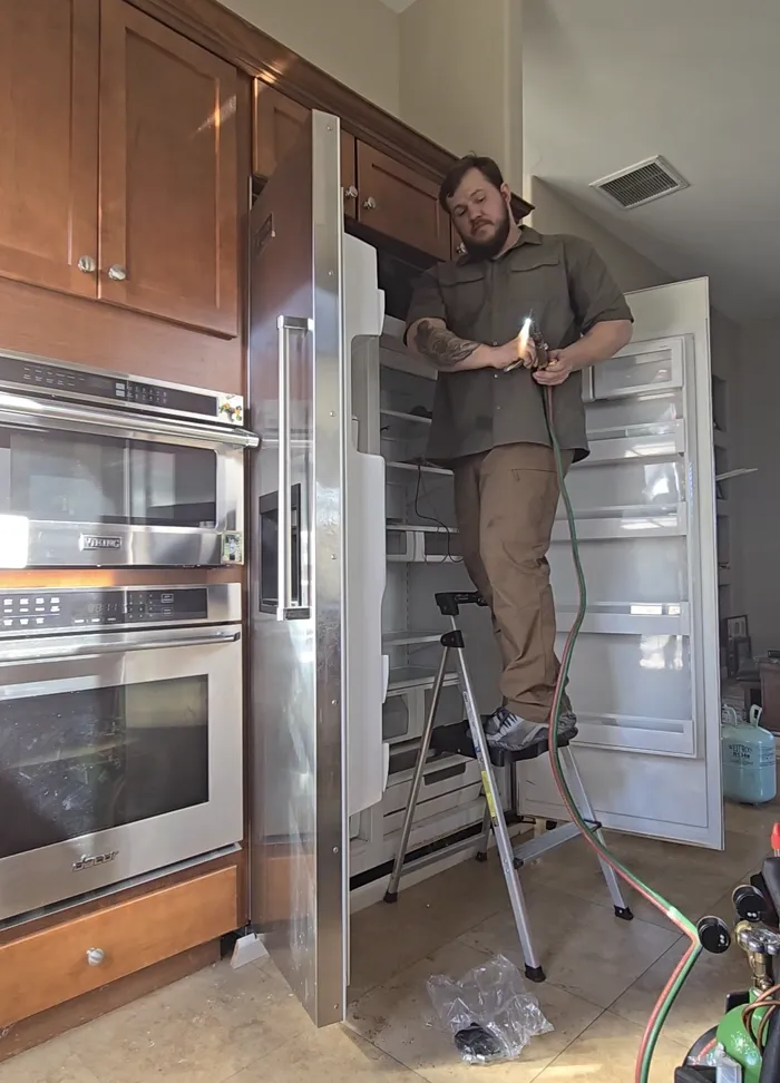ProMaster technician servicing a commercial Hobart dishwasher